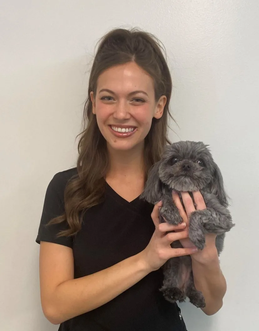 Karli holding a small grey dog